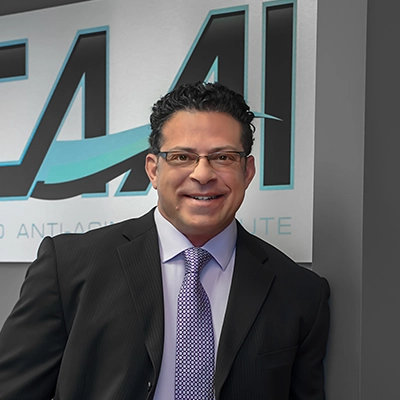 Loren Davis Smiling In A Suit In The Office