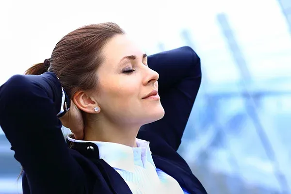 Woman Relaxing With Her Arms Behind Her Head